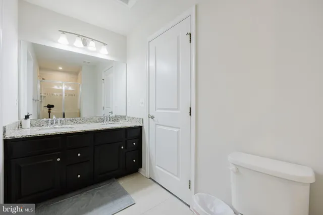 a bathroom with a double vanity sink and a toilet