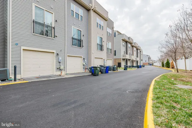 a couple of potted plants in front of brick building