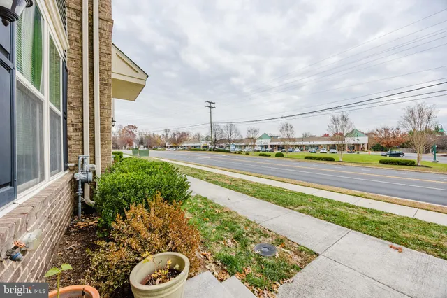 a view of a street with a houses in the background