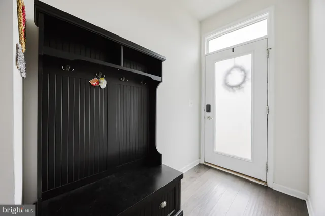an empty room with wooden floor and cabinet