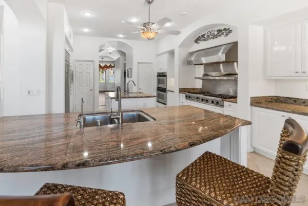 a stove top oven sitting inside of a kitchen