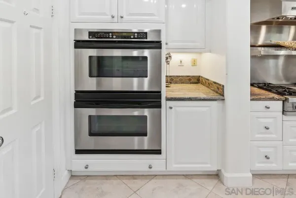 an empty room with windows and entrance