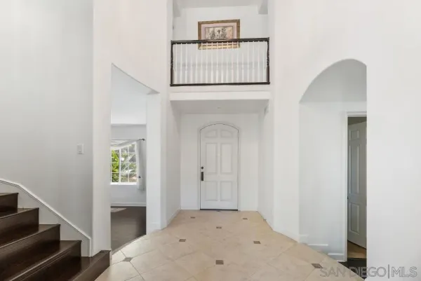 a view of a room with wooden floor and a potted plant