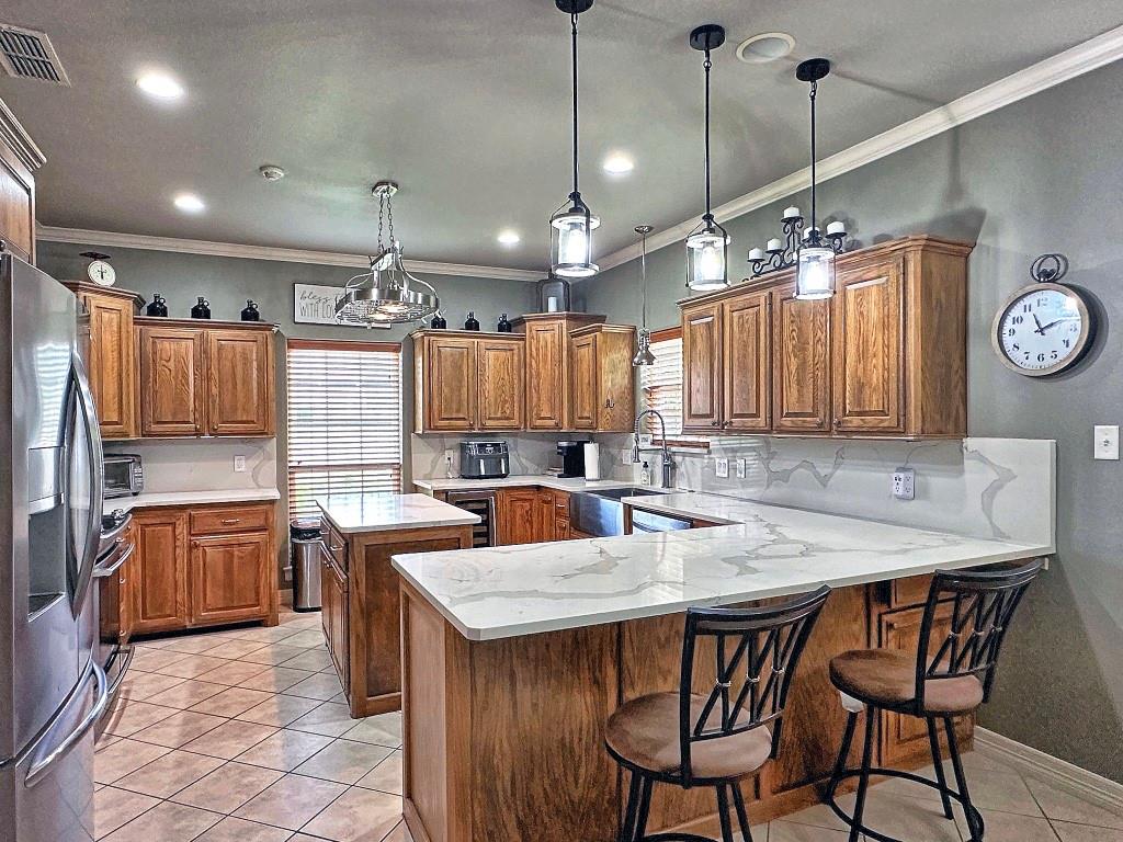 912 Van Winkle Circle Athens, TX 75751 - Photo 4 of 14 a kitchen with stainless steel appliances kitchen island granite countertop a sink a stove a dining table and chairs