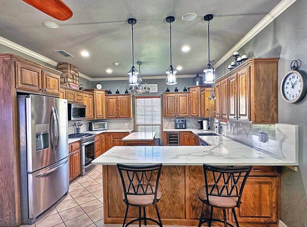 912 Van Winkle Circle Athens, TX 75751 - Photo 5 of 14 a kitchen with stainless steel appliances a dining table chairs stove refrigerator and cabinets