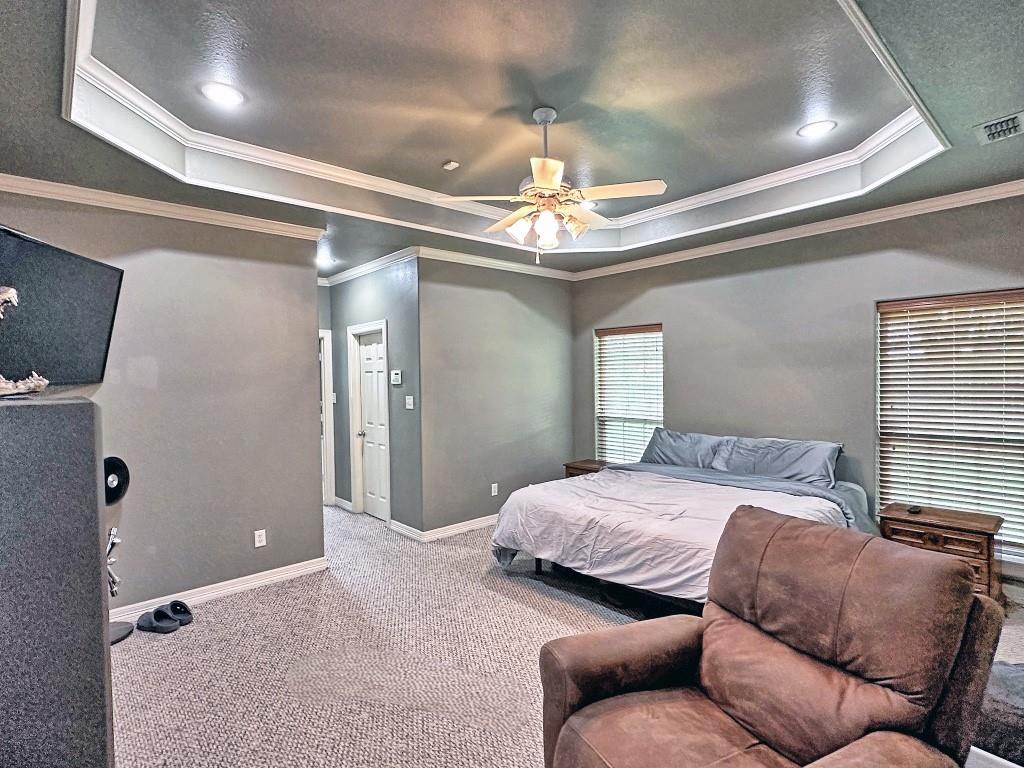 912 Van Winkle Circle Athens, TX 75751 - Photo 8 of 14 a bedroom with a bed couch and flat screen tv