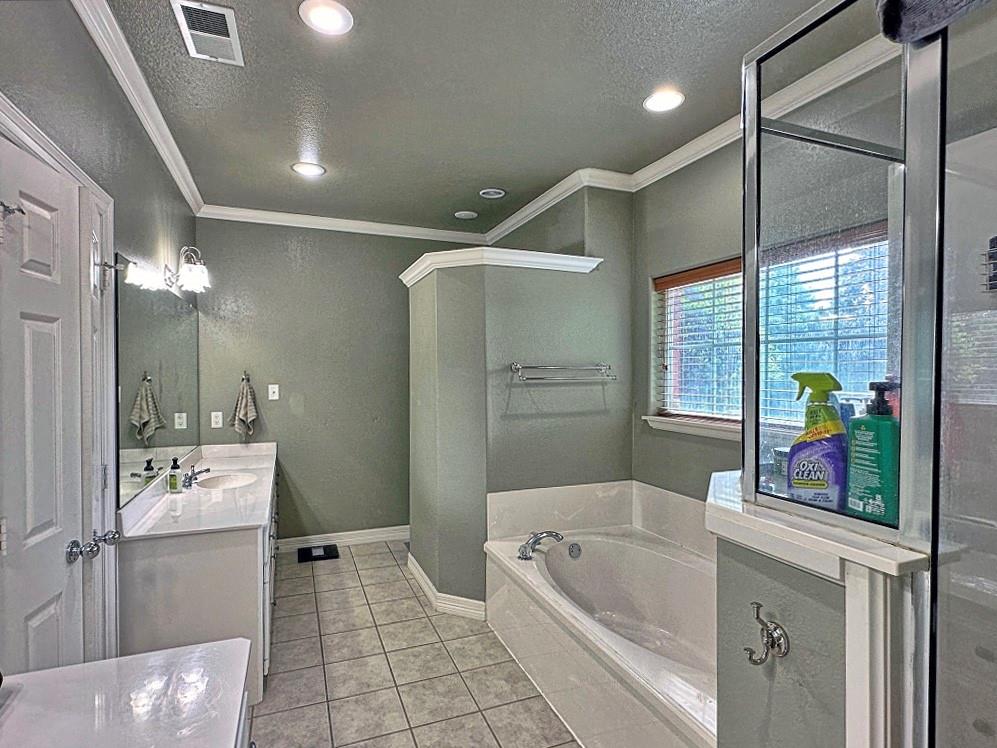912 Van Winkle Circle Athens, TX 75751 - Photo 9 of 14 a bathroom with a tub sink and mirror