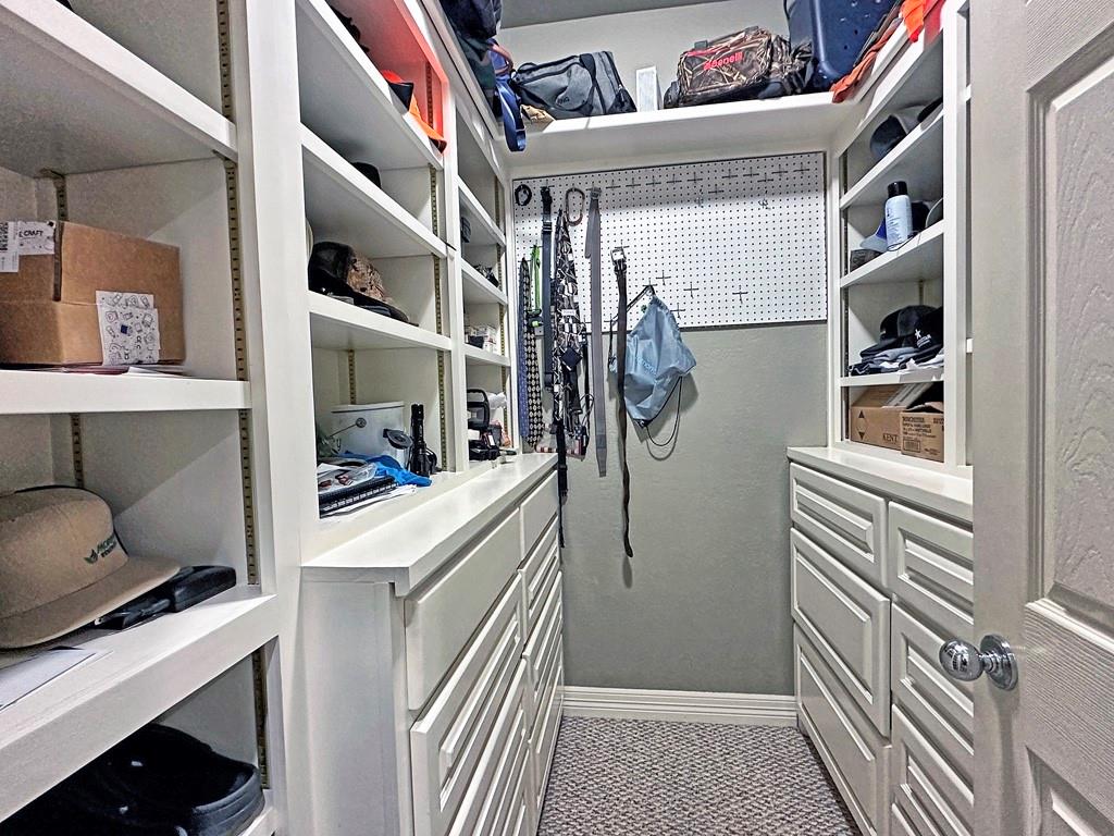 912 Van Winkle Circle Athens, TX 75751 - Photo 10 of 14 a view of walk in closet with clothes and shoes