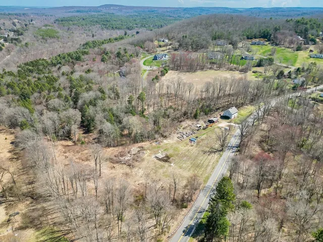 an aerial view of house with yard and mountain view