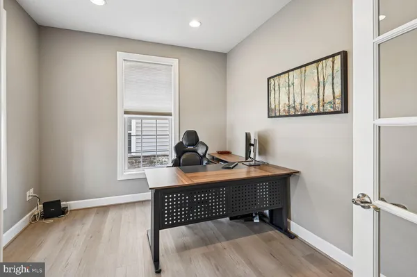 a view of a workspace with furniture and a window