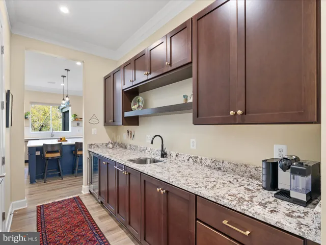 a kitchen with stainless steel appliances granite countertop a sink and a stove