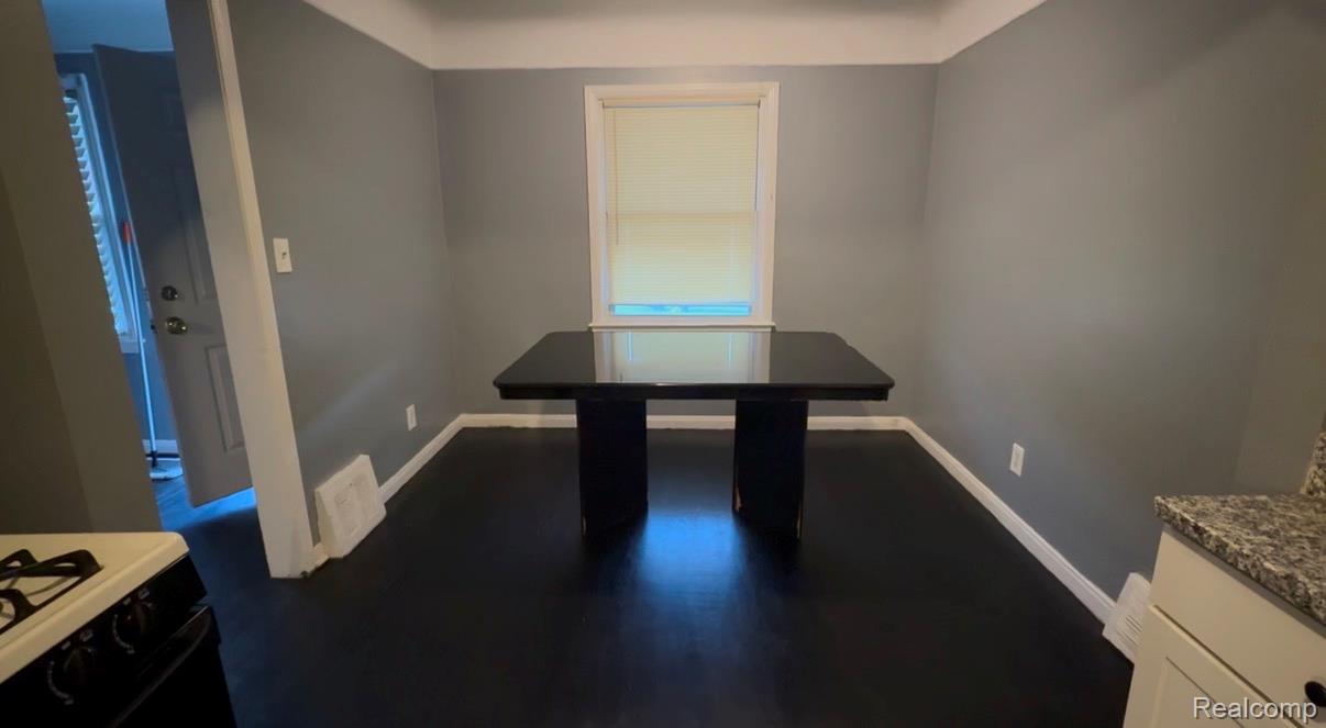 7633 Fielding Street Detroit, MI 48228 - Photo 12 of 12 Dining area featuring dark wood-finish flooring, light gray wall paint, and white trim