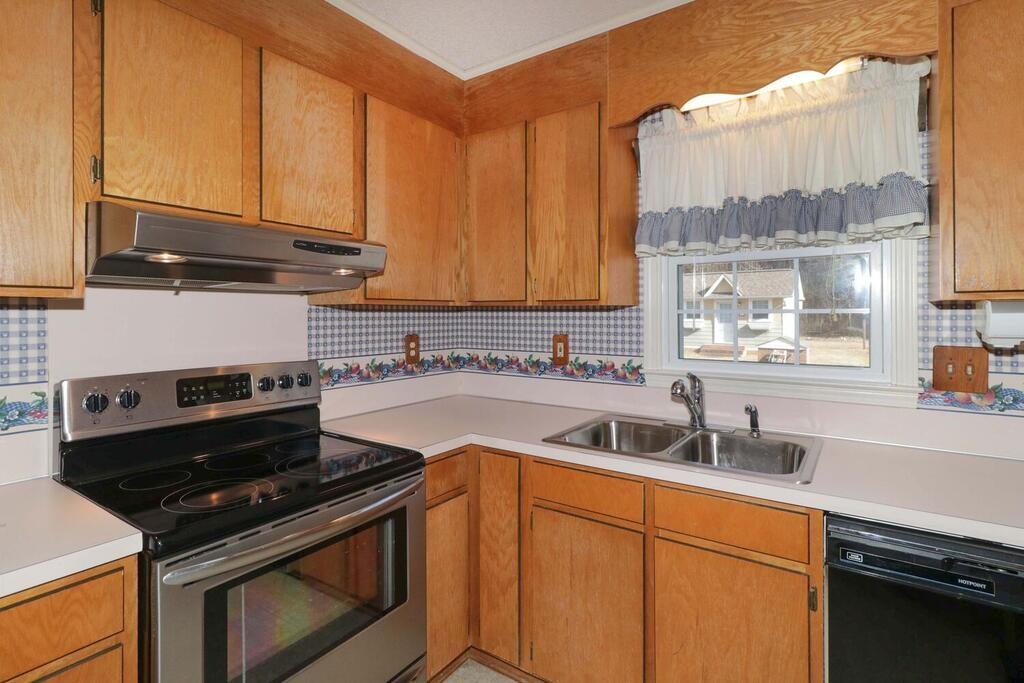 2245 Barger Road Salisbury, NC 28146 - Photo 12 of 48 a kitchen with a sink stove top oven and cabinets