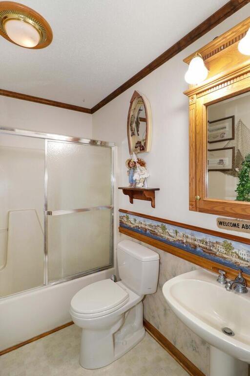 2245 Barger Road Salisbury, NC 28146 - Photo 22 of 48 a bathroom with a toilet sink a mirror and shower