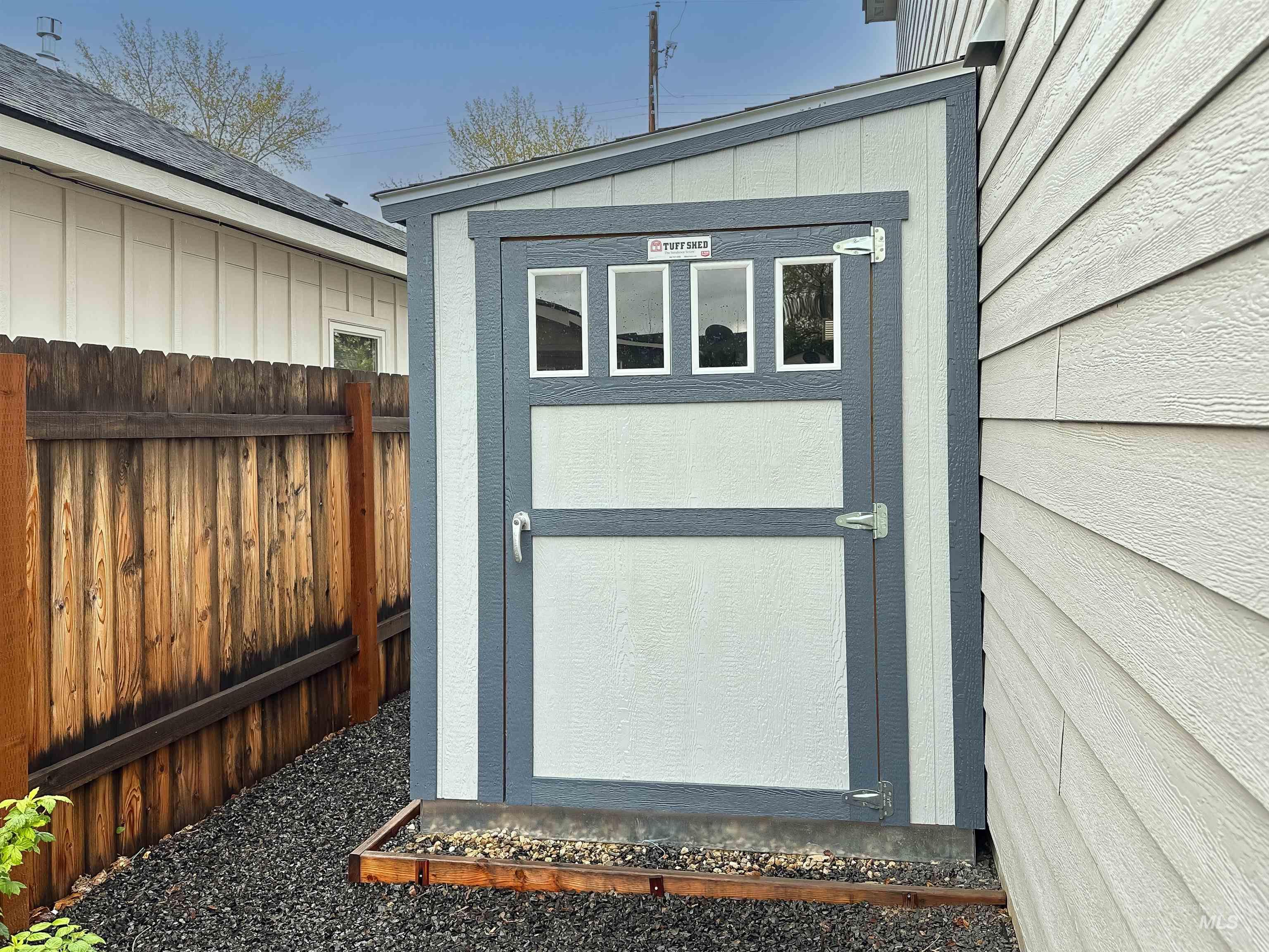 9687 West Arnold Road Boise, ID 83714 - Photo 30 of 37 Detached storage shed with a lean-to roof design, featuring a paneled door with integrated windows