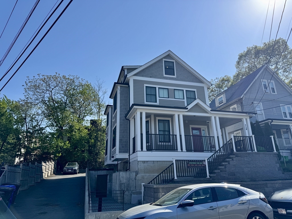 13 Greylock Road, Unit 1 Boston, MA 02134 - Photo 1 of 11 a front view of a house with cars parked