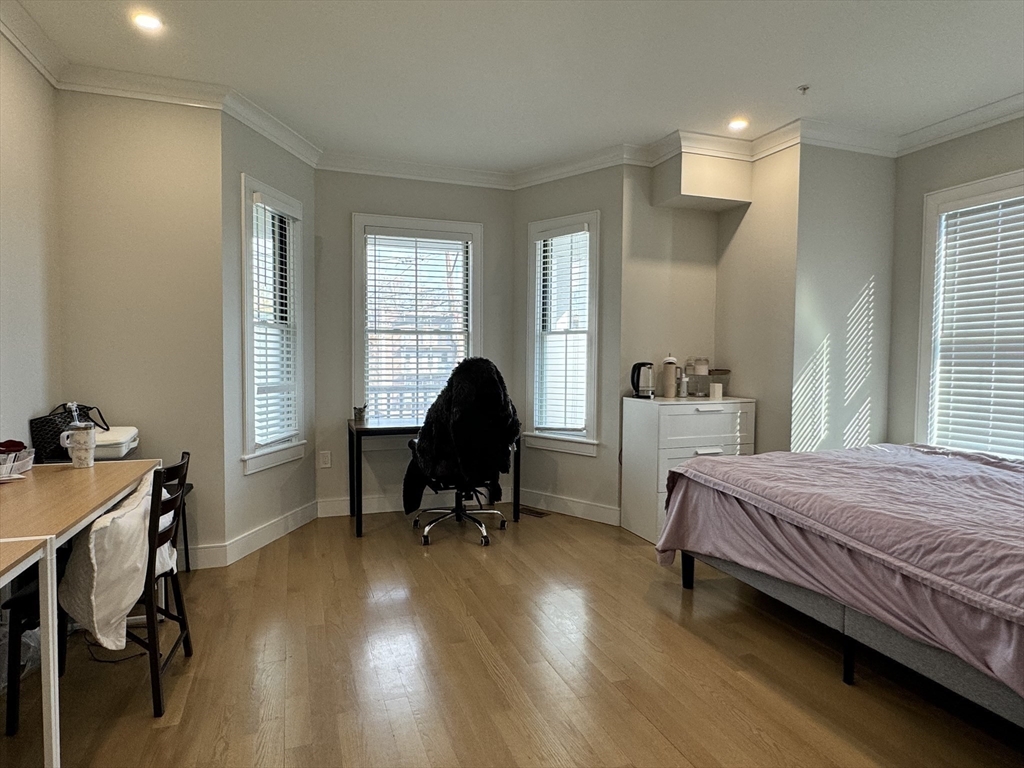 13 Greylock Road, Unit 1 Boston, MA 02134 - Photo 6 of 11 a bedroom with a bed and a desk