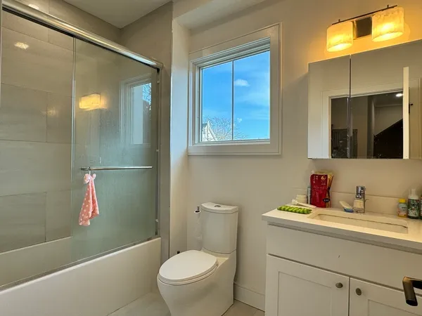 a bathroom with a sink toilet and shower