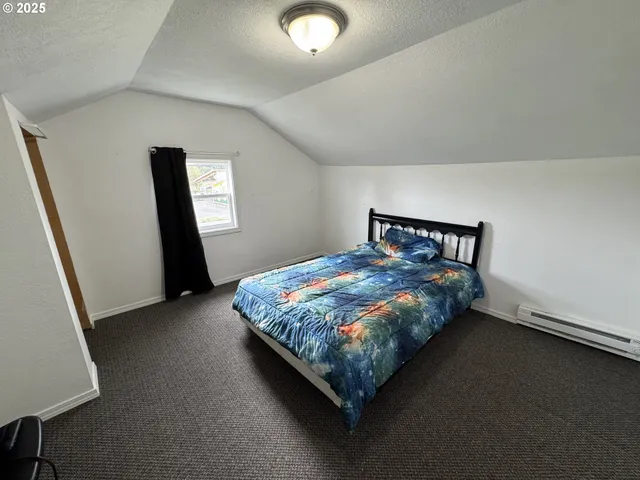 a bed sitting in a room next to a window