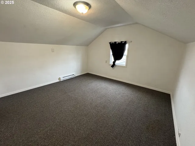 an empty room with a empty space and windows