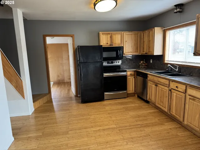 a kitchen with stainless steel appliances granite countertop a refrigerator sink and cabinets