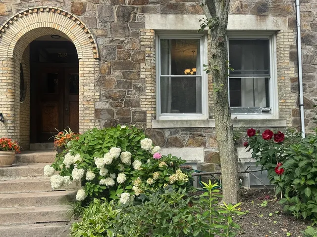 a front view of a house with a garden