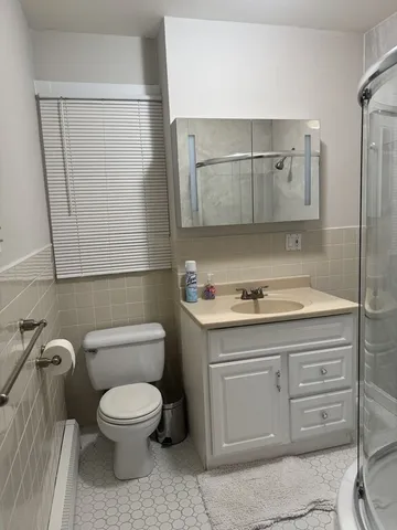 a bathroom with a toilet sink and mirror