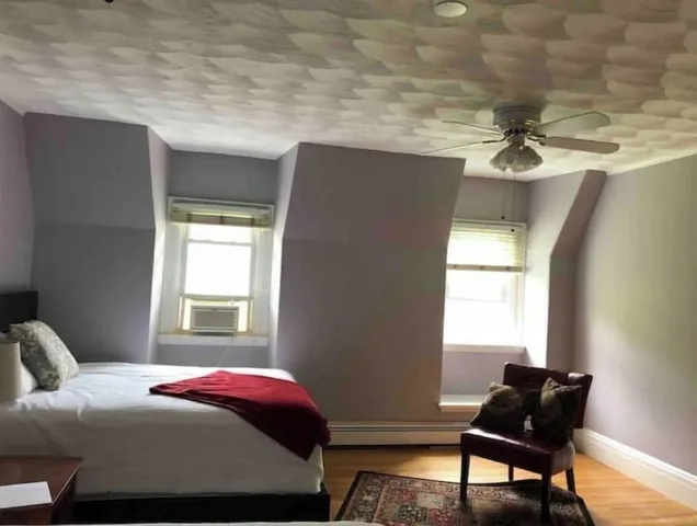 a bedroom with a bed and window