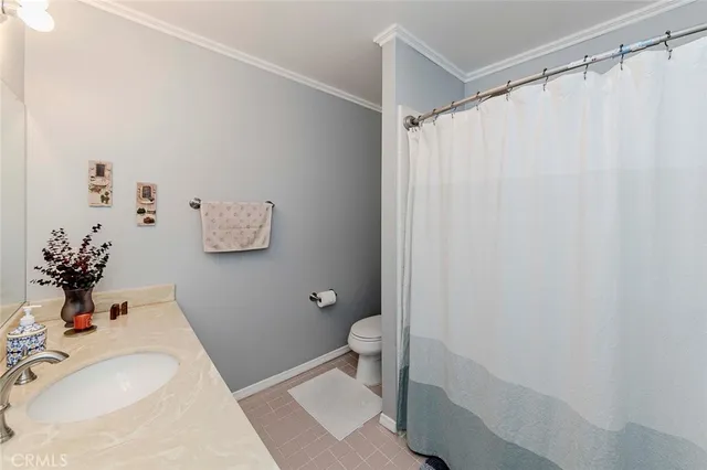 a bedroom with a bed window and wooden floor