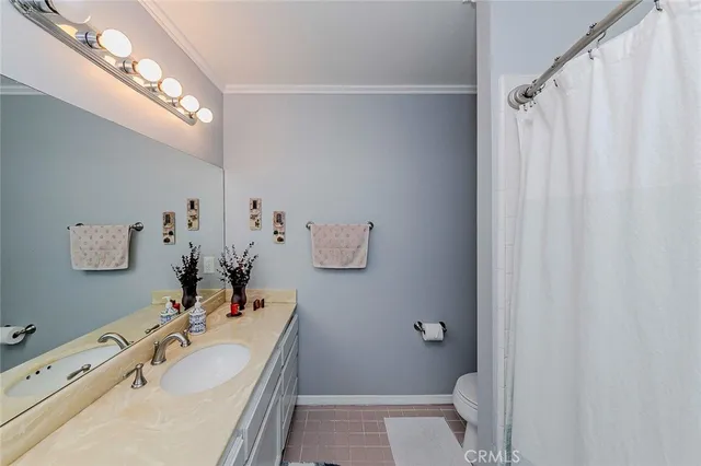 a spacious bedroom with a bed and a chandelier