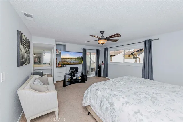 a bedroom with a large bed and a large window