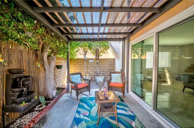 a view of a house with swimming pool and sitting area