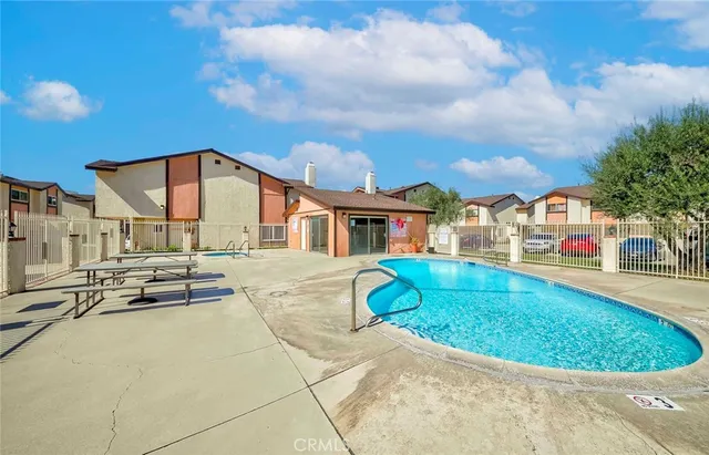 a view of a backyard with table and chairs and a large tree