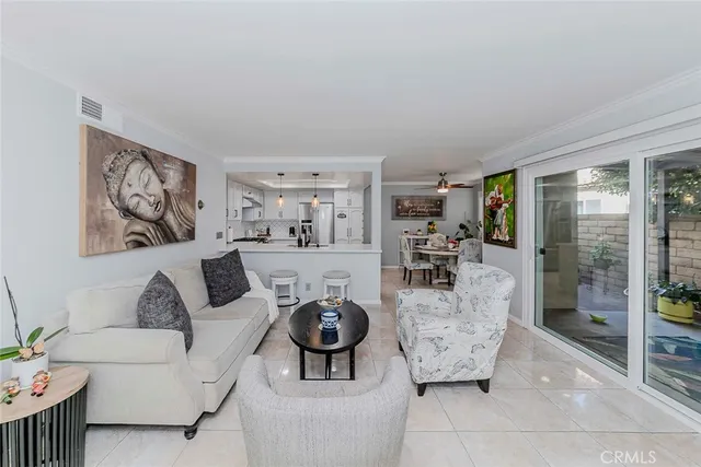 a living room with furniture and a dining table with wooden floor