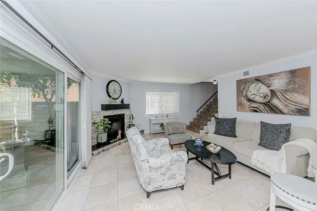 a living room with furniture and a dining table