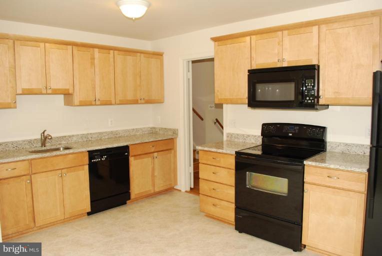 4205 Sleepy Hollow Road Annandale, VA 22003 - Photo 2 of 14 a kitchen with stainless steel appliances granite countertop a stove microwave and sink