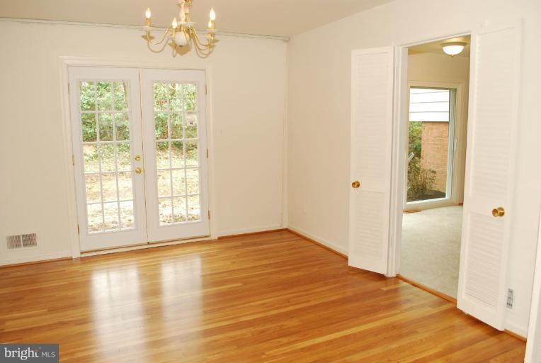 4205 Sleepy Hollow Road Annandale, VA 22003 - Photo 3 of 14 an empty room with wooden floor and windows