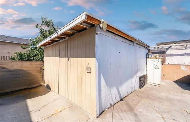a spacious bedroom with a bed table and a chandelier