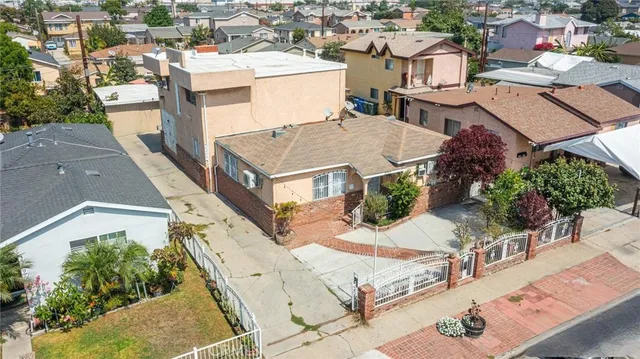 an aerial view of a house with wooden floor and city view