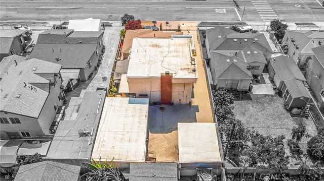 an aerial view of residential houses with outdoor space