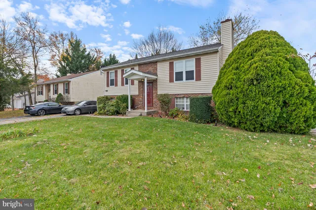 a front view of a house with a garden and yard