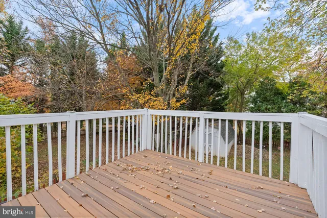 a view of balcony with wooden floor and fence