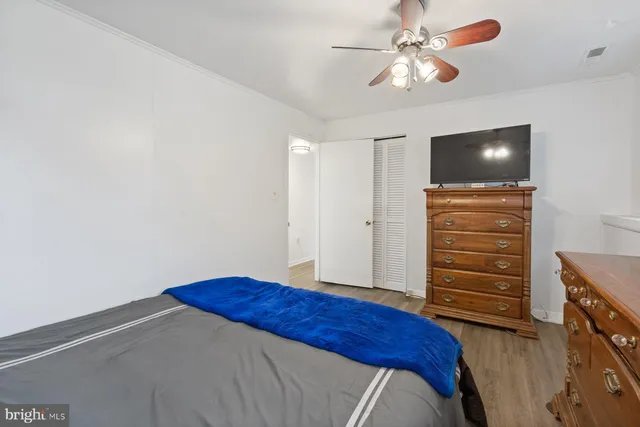 a bedroom with a bed and a ceiling fan