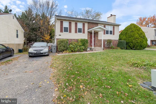 a front view of a house with a garden and plants
