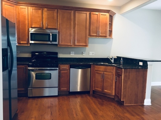 172 Mayo Court Elmhurst, IL 60126 - Photo 3 of 6 a kitchen with granite countertop a stove and a microwave