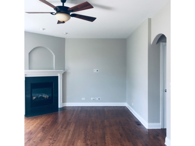172 Mayo Court Elmhurst, IL 60126 - Photo 4 of 6 a view of an empty room with a fireplace and a window