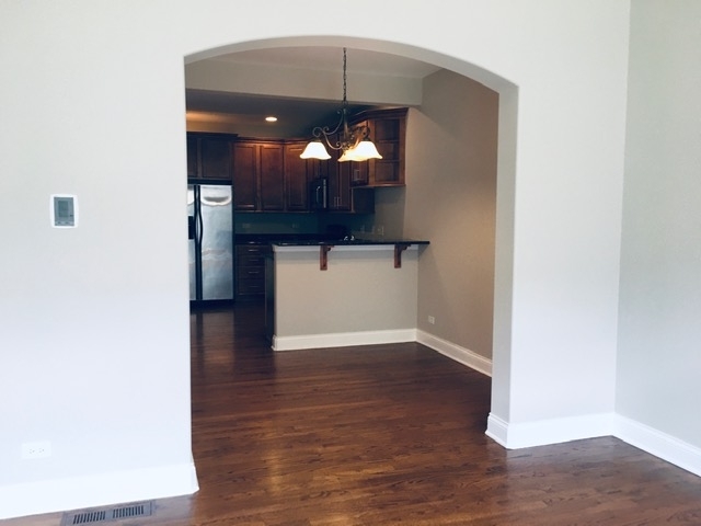 172 Mayo Court Elmhurst, IL 60126 - Photo 5 of 6 a view of a hallway with wooden floor and entryway