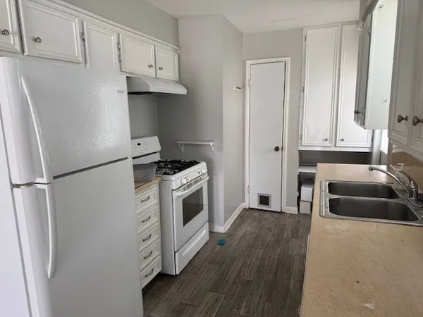 a kitchen with stainless steel appliances a refrigerator stove and sink