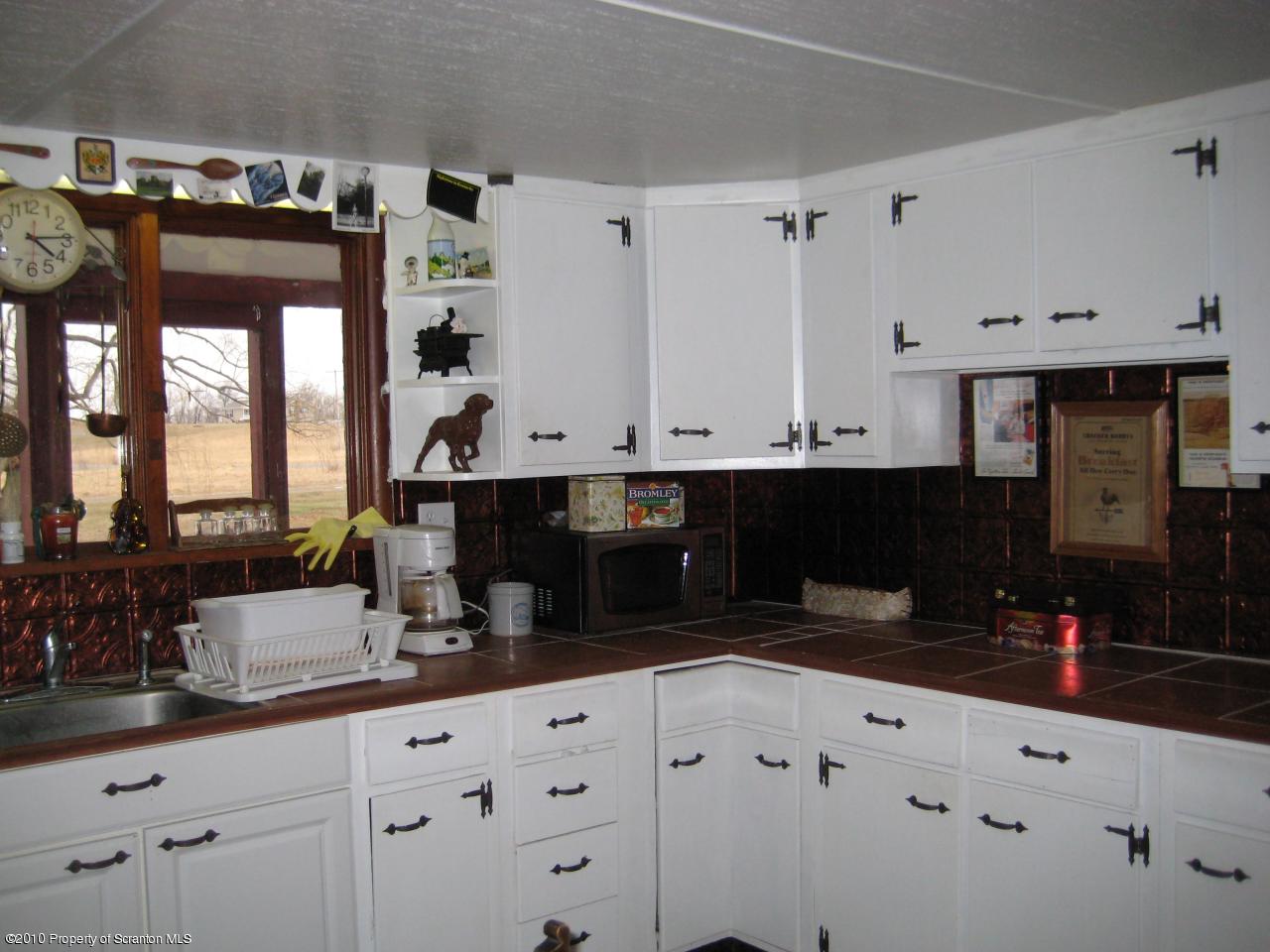 Rr2 Rr2 Ulster, PA 18850 - Photo 3 of 12 a kitchen with granite countertop white cabinets and black appliances