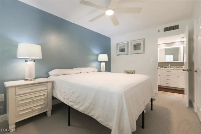 a bedroom with a bed and a lamp